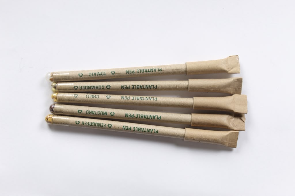 Plantable pens made from recycled kraft paper, each printed with the seed it grows